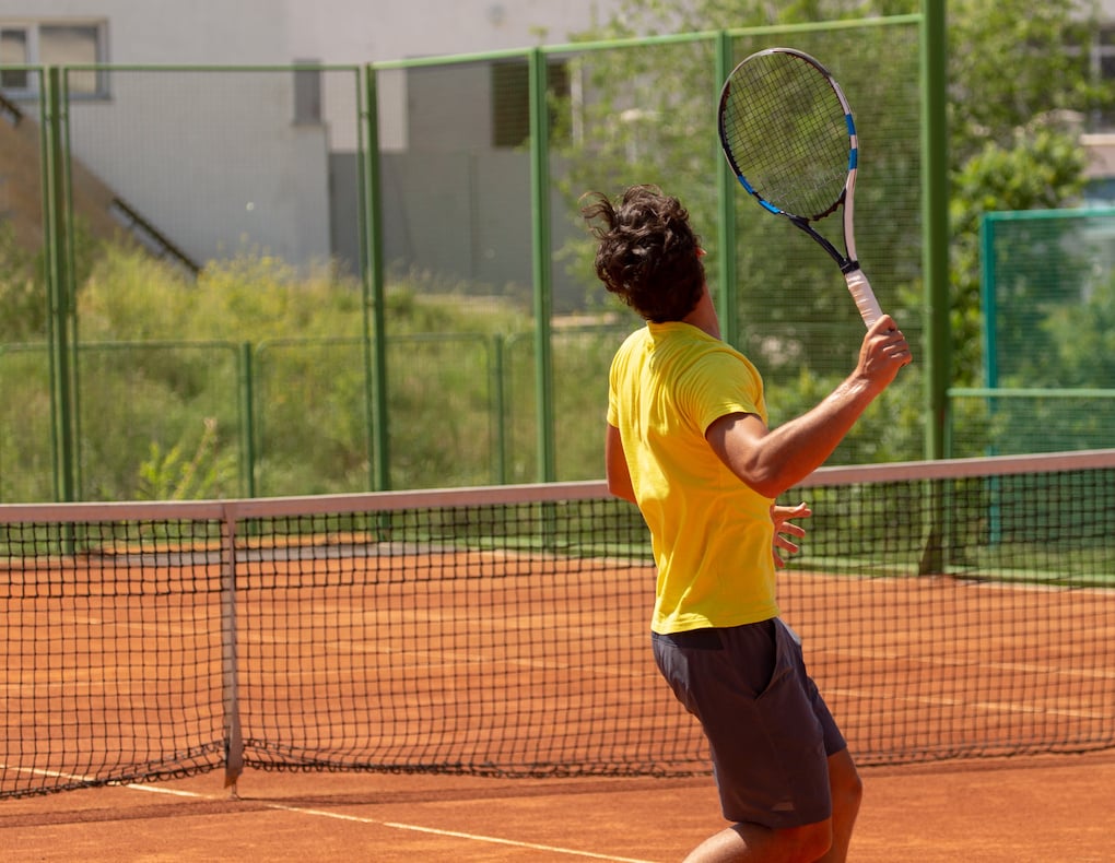 a man plays tennis on wayzata parks tennis courts 